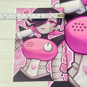 May include: A pink and white illustration of a robot with a pink phone on its chest. The robot has pink hair and a white and black outfit. The background is pink with white hearts.