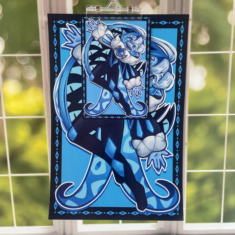 May include: An art print with a blue and black jester design. The jester has a diamond pattern on their clothing. The artwork is set against a light blue background and has a decorative border.