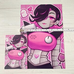 May include: A pink and black illustration of a robot character with a pink heart on its chest. The character has black hair and a pink phone on its chest. The background is pink with white squares.