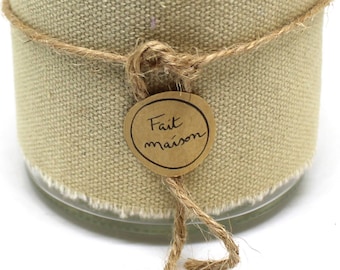 May include: A glass candle jar with a beige fabric cover and a brown twine bow. The jar has a brown paper label with the text "Fait maison" in French.