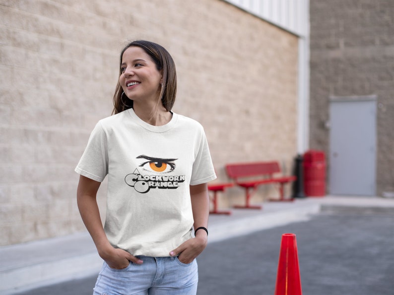 K&ouml;nnte beinhalten: Wei&szlig;es T-Shirt mit einem Grafikdruck eines stilisierten Auges und dem Text "A Clockwork Orange".
