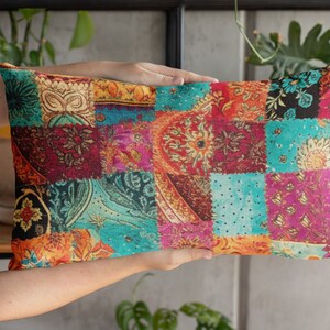 May include: A colorful patchwork pillow with a variety of floral and geometric patterns in shades of red, blue, green, and yellow.
