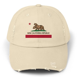 May include: A beige distressed baseball cap with a red, white, and green California flag design. The flag features two bears and the text "NEW CALIFORNIA REPUBLIC".