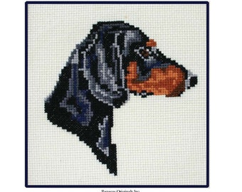 May include: Counted cross stitch chart for a dachshund, titled "Dachshund" and numbered "4874-D". The chart is from Pegasus Originals, Inc. and features a black and brown dachshund with a white chest.