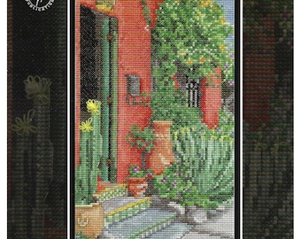 May include: Cross stitch pattern for a colorful scene of a red building with a green door and a lush garden with cacti and a potted plant. The pattern is titled "Tucked Away Tucson" and is designed by Stephanie Seabrook Hedgepath. The pattern number is #508.
