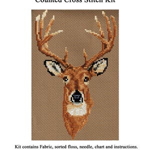 May include: White Tailed Deer Head Study Counted Cross Stitch Kit featuring a brown deer head design on tan fabric. The text reads White Tailed Deer Head Study Counted Cross Stitch Kit, Kit contains Fabric, sorted floss, needle, chart and instructions. Designed by Stephanie Seabrook Hedgepath, Pegasus Originals Inc., www.pegasusoriginals.com.