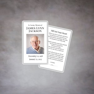 May include: A memorial card with a photo of James Lynn Jackson, born December 23, 1978, and passed January 25, 2023. The card includes the text "In Loving Memory of" and a poem titled "Fill Not Your Heart."