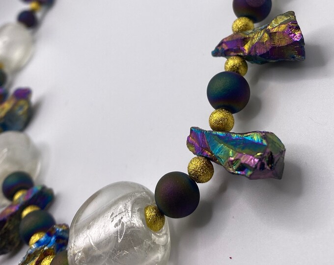 Large crystal like beads, iridescent stones, and peacock agates with gold bead necklace.