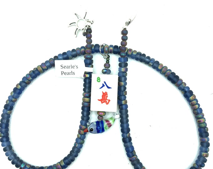 21" necklace made of abacus glass beads with an 8 crack bone and bamboo mahjong tile that has a small glass fish at the end.