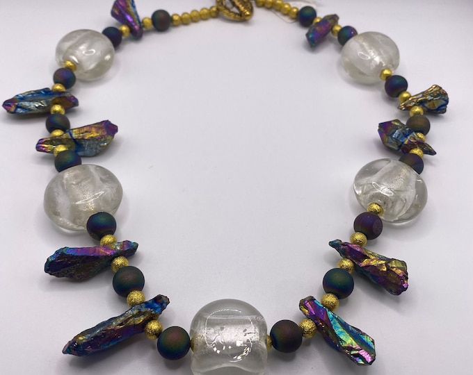 Large crystal like beads, iridescent stones, and peacock agates with gold bead necklace.