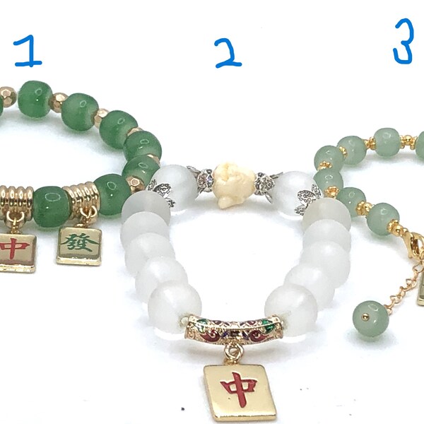 Bracelets with jade beads and metal mahjong tiles.