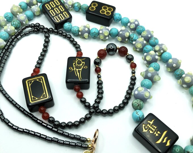 Unusual mahjong necklaces with black tiles.