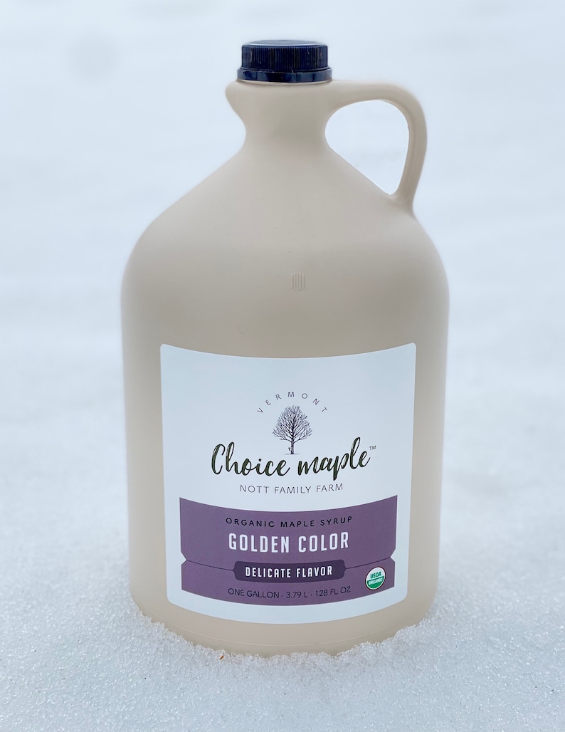 May include: A gallon jug of Vermont Choice maple syrup, a golden color, with a delicate flavor. The label says "Organic Maple Syrup, Golden Color, Delicate Flavor, One Gallon - 3.79 L - 128 fl oz".