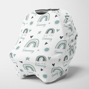May include: White car seat cover with a repeating pattern of green and black rainbows, stars, hearts, and suns. The name "Sammy" is repeated throughout the pattern.