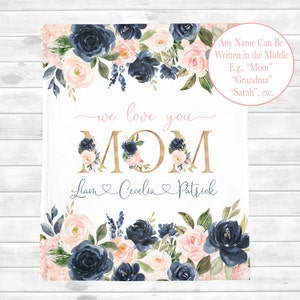 May include: A white background with a gold "MOM" surrounded by blue and pink watercolor flowers. The text "we love you" is written above the "MOM" and the text "Liam Cecelia Patrick" is written below. The text "Any Name Can Be Written in the Middle E.g., "Mom" "Grandma" "Sarah", etc." is written in the top right corner.