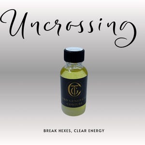 May include: A small glass bottle with a black cap and a black label featuring gold text and a circular emblem. The bottle contains a yellow liquid. The words "Uncrossing" and "Break Hexes, Clear Energy" are also visible.