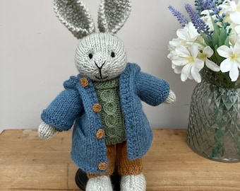 Hand knitted Bunny in Blue Duffle Coat, Tan Trousers, Green Jumper