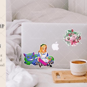 May include: A laptop computer with three stickers on it. The stickers are of a bouquet of pink flowers, Alice in Wonderland reading a book with the Cheshire Cat, and an Apple logo. The laptop is on a white bedspread with a wooden tray and a white coffee mug on the tray.