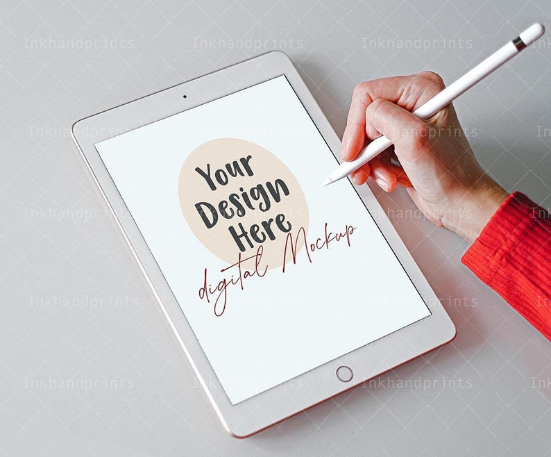May include: A white tablet with a blank screen and a hand holding a stylus pen. The tablet has the text "Your Design Here digital Mockup" on the screen.