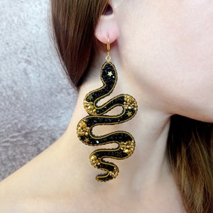 Black and gold snake earrings. Serpent earrings. Statement beaded earrings.