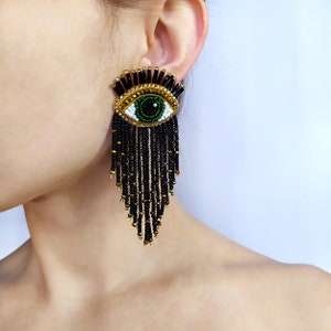 Evil eye beaded earrings. Black and gold fringe earrings.