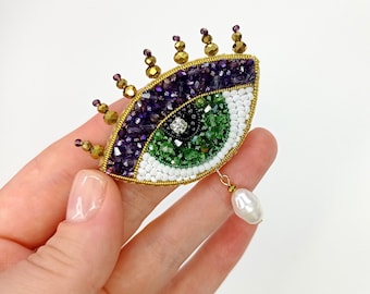 Evil eye brooch with pearl pendant. Green eye brooch. Purple green brooch.