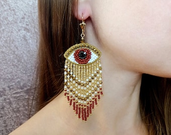 Evil eye beaded earrings. Gold and brown fringe earrings.