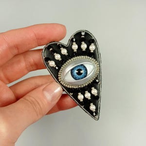 Evil eye heart brooch. Black silver heart brooch. Blue eye brooch.