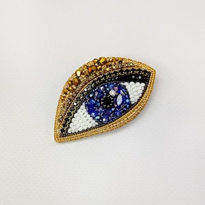 Evil eye brooch. Blue eye brooch.  Gold blue eye pin.