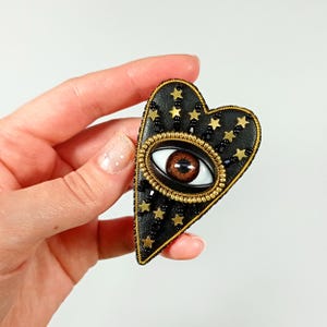 Evil eye heart brooch. Black gold heart brooch. Brown eye brooch.