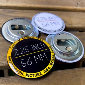 May include: Three 2.25 inch round bottle openers with a black and yellow design, a white design, and a silver design. The text on the black and yellow bottle opener reads "Custom Design Here 2.25 Inch 56 MM Photograph, Picture, Idea, Words, Logo".