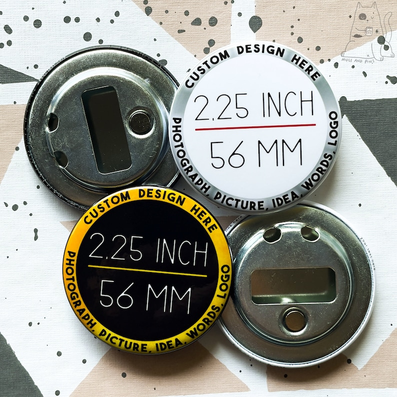 May include: Two 2.25 inch round button blanks with bottle opener backs. One blank is white with black text and a red line. The other blank is black with yellow text and a yellow line. Both blanks have the text "CUSTOM DESIGN HERE", "PHOTOGRAPH PICTURE, IDEA, WORDS, LOGO", and "2.25 INCH", "56 MM".