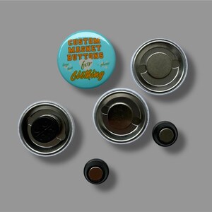 May include: A selection of custom magnet buttons for clothing. The buttons are round with a teal background and orange text that reads "CUSTOM MAGNET BUTTONS for CLOTHING". The image shows the front and back of the buttons.