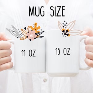 May include: Two white ceramic mugs with floral designs. The mug on the left is 11 oz and the mug on the right is 15 oz.