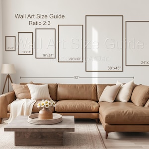 May include: A wall art size guide with a 2:3 ratio, displaying six rectangular frames in sizes 8x12, 12x18, 16x24, 20x30, 30x45, and 24x36 inches. The text Wall Art Size Guide is visible above a brown sectional sofa with a 92-inch width indicator.