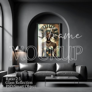 May include: A framed art print featuring a portrait of a woman with a decorative headdress and jewelry. The artwork is displayed above a dark gray leather sectional sofa. The room has a modern, minimalist design with a dark color palette.