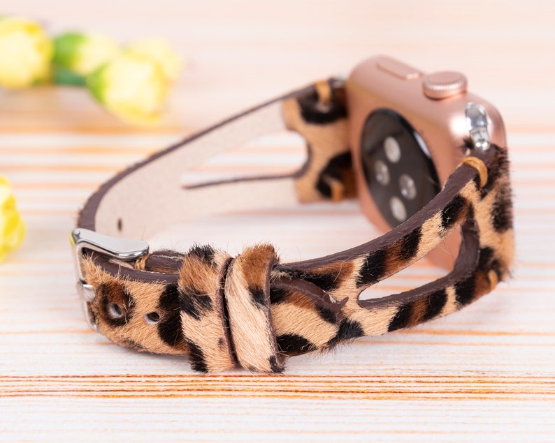 May include: A brown and black leopard print Apple Watch band with a rose gold watch face.