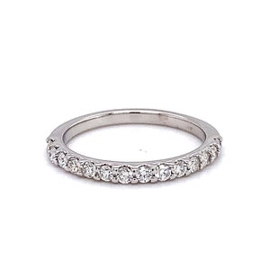 May include: A thin silver band with a row of small, clear diamonds set in a pave setting.