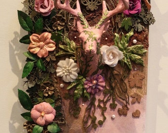 May include: A pink deer head with antlers, surrounded by flowers, leaves, and lace. The background is a textured canvas with a pink and brown colour scheme. The text "Distinct Disarray" is in the bottom right corner.