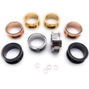 Könnte beinhalten: Ein Set aus sechs Ohrdehnern in verschiedenen Farben, darunter Schwarz, Silber, Gold und Roségold. Die Dehner sind aus Metall und haben eine glatte, polierte Oberfläche. Jeder Dehner hat einen kleinen Ring, der an der Unterseite befestigt ist.