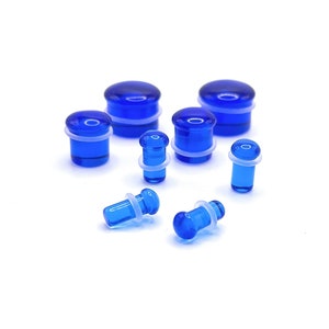 May include: A set of blue glass ear gauges with white o-rings. The gauges are in various sizes and are perfect for stretching your earlobes.