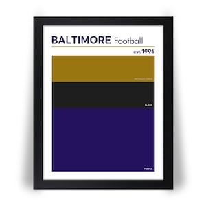 May include: Framed art print featuring the words "BALTIMORE Football" above a design with horizontal stripes in metallic gold, black, and purple. The text "est.1996" is above the stripes. The colors are labeled "METALLIC GOLD", "BLACK", and "PURPLE".