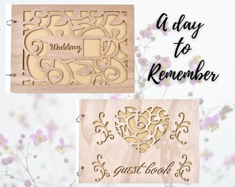 May include: A wooden guest book with a heart-shaped cutout and the text "Guest Book" engraved on the front. The heart cutout has a delicate floral design. The book is light brown in color and has a rustic look. The text "A day to Remember" is written in black on a white background.