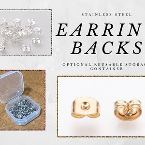 May include: A close-up of two gold earring backs. The earring backs are made of stainless steel and are shown on a white background. The image also shows a small clear container filled with silver earring backs.