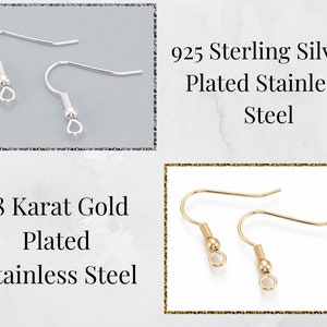 May include: Two pairs of earring hooks, one pair is silver plated and the other is gold plated. The text on the image reads "925 Sterling Silver Plated Stainless Steel" and "18 Karat Gold Plated Stainless Steel".