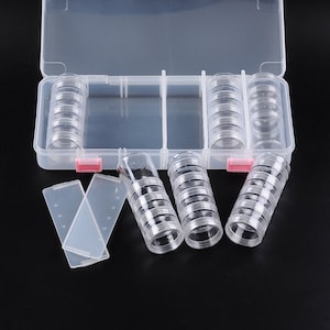 May include: A clear plastic storage box with multiple compartments for organizing small items. The box comes with several stackable, clear plastic containers.