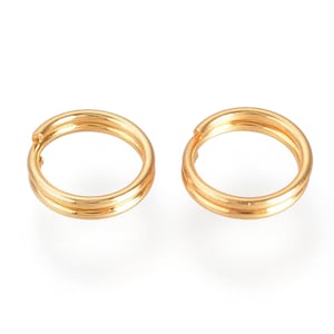 May include: Two gold-coloured jump rings, each with a diameter of approximately 1.25 cm.