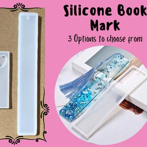 May include: Three silicone molds for making book marks. The molds are white and rectangular. One mold has a heart shape in the center. The other two molds are plain. The image text reads "Silicone Book Mark 3 Options to choose from".