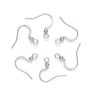 May include: Six silver earring hooks with a small ball at the top of each hook.
