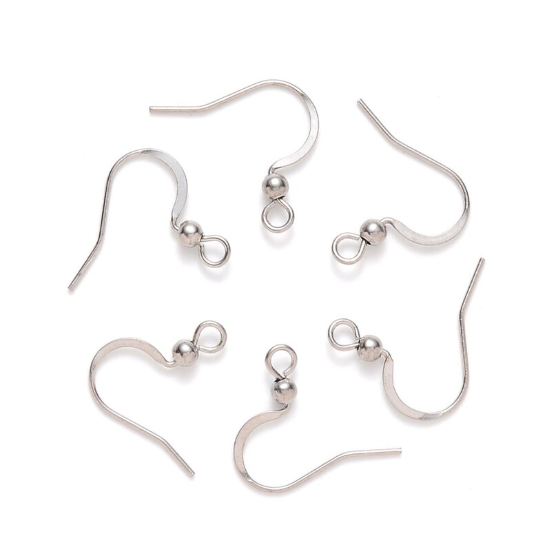 May include: Six silver earring hooks with a small ball at the top of each hook.